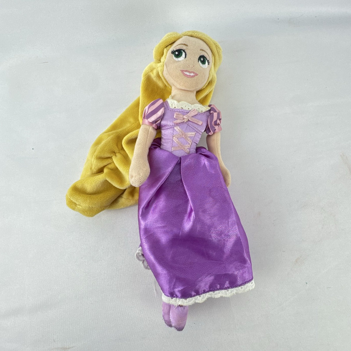 Disney Tangled Rapunzel 11-inch plush doll wearing purple satin dress