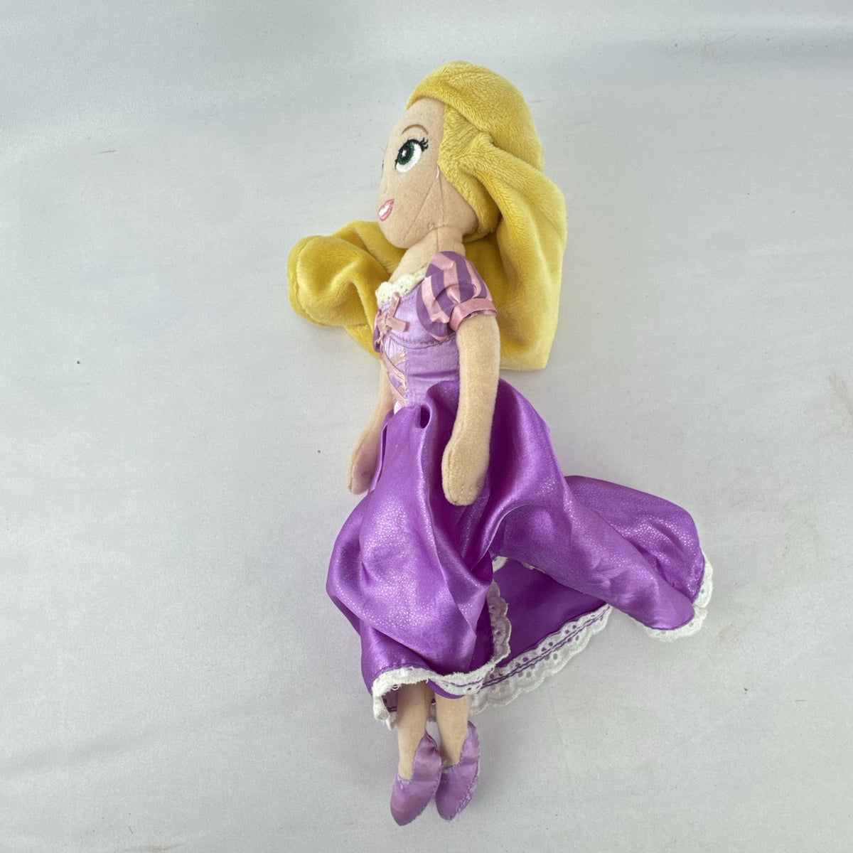 Disney Tangled Rapunzel 11-inch plush doll wearing purple satin dress
