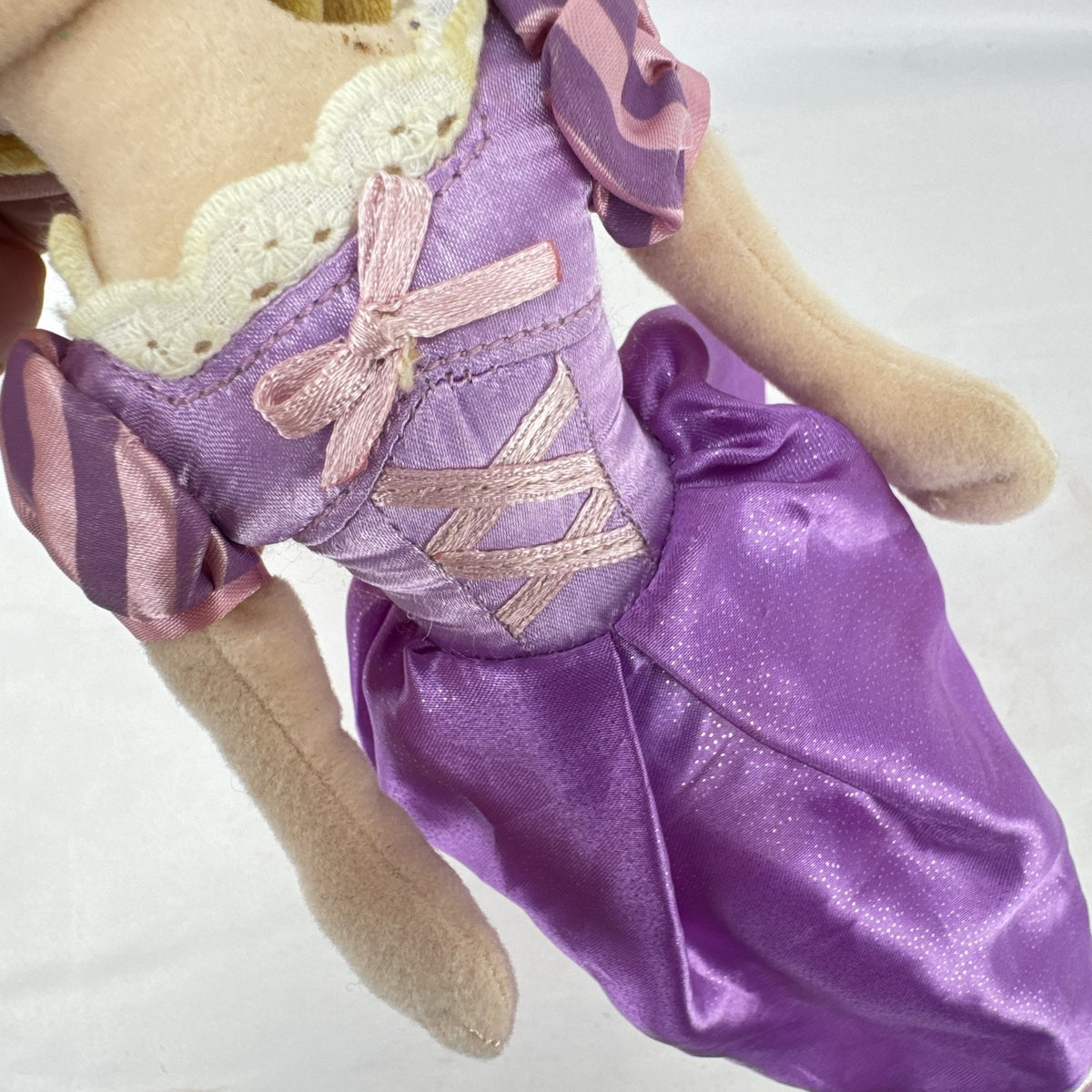Disney Tangled Rapunzel 11-inch plush doll wearing purple satin dress