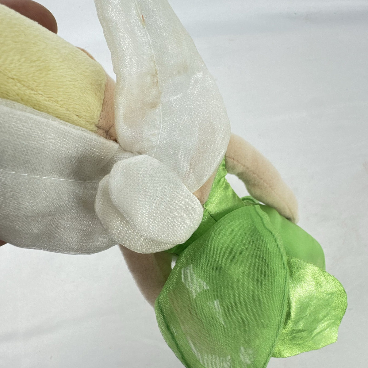 Disney Tinker Bell plush doll with iridescent wings and green petal dress, approximately 11 inches tall.