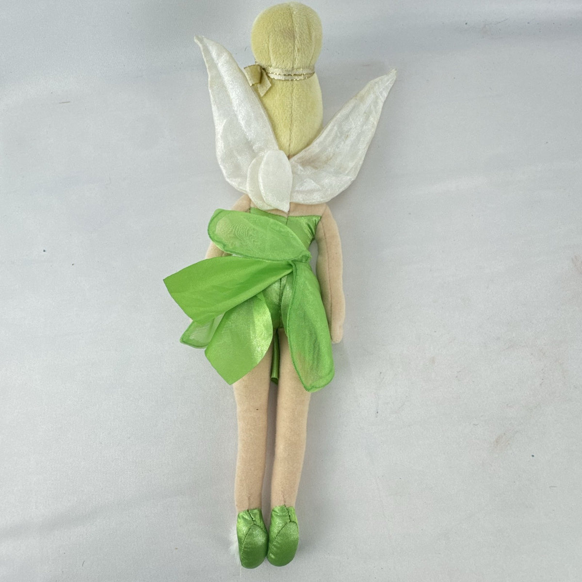 Disney Tinker Bell plush doll with iridescent wings and green petal dress, approximately 11 inches tall.