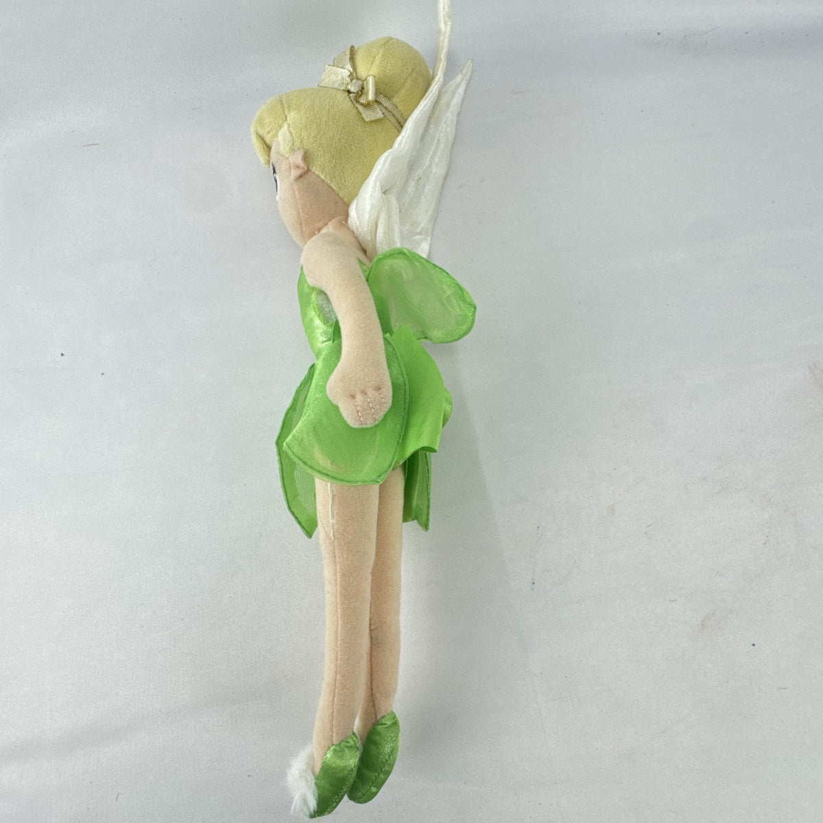 Disney Tinker Bell plush doll with iridescent wings and green petal dress, approximately 11 inches tall.