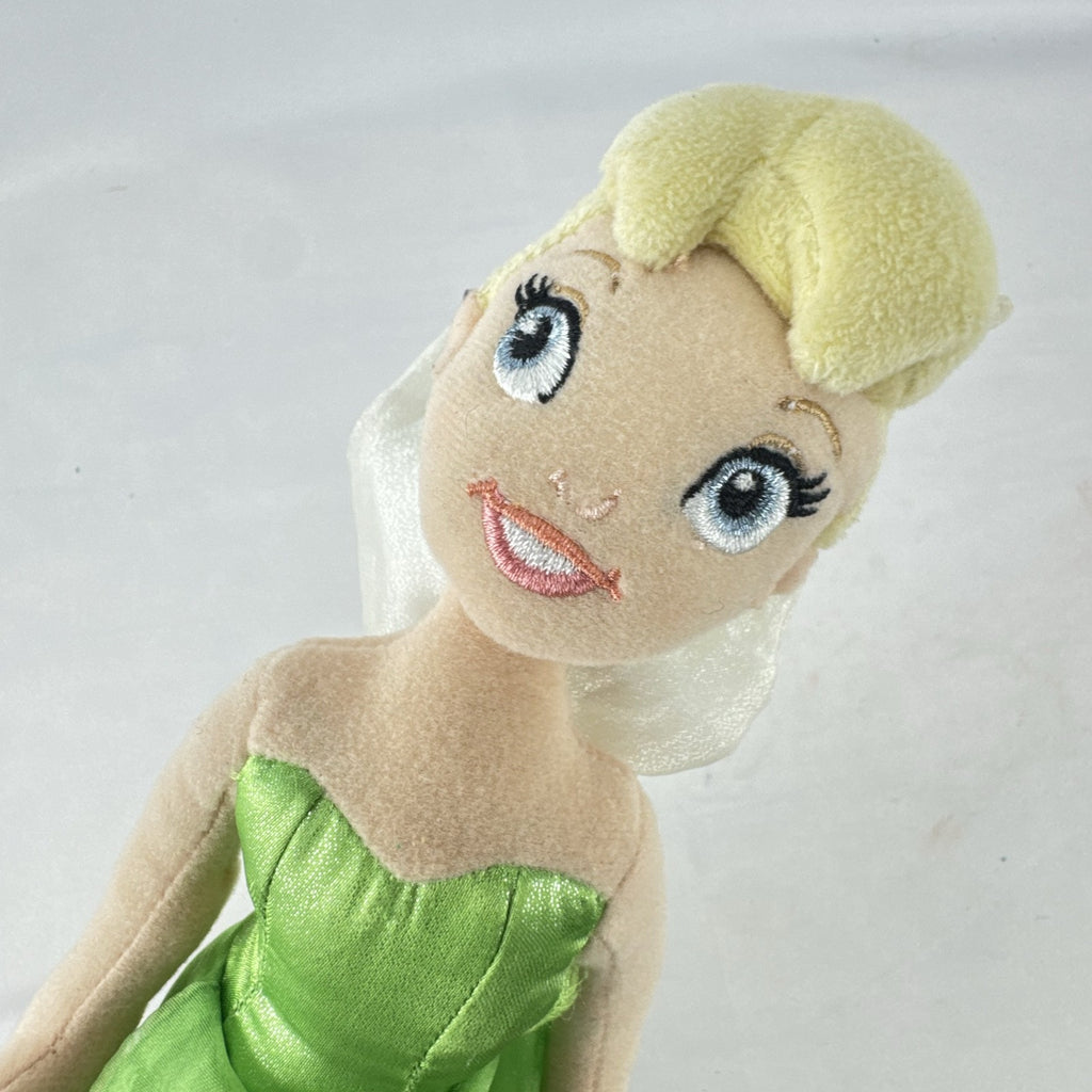 Disney Tinker Bell plush doll with iridescent wings and green petal dress, approximately 11 inches tall.