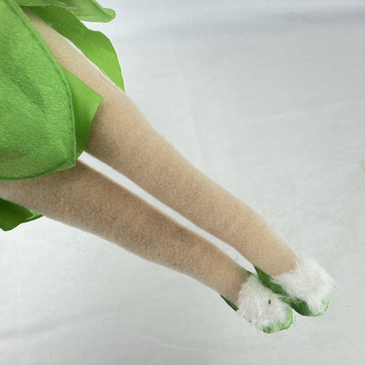 Disney Tinker Bell plush doll with iridescent wings and green petal dress, approximately 11 inches tall.