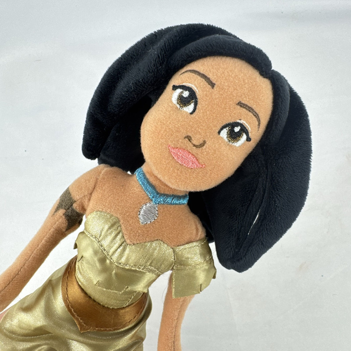 Disney Pocahontas 11-inch plush doll wearing gold satin fringe dress and turquoise necklace