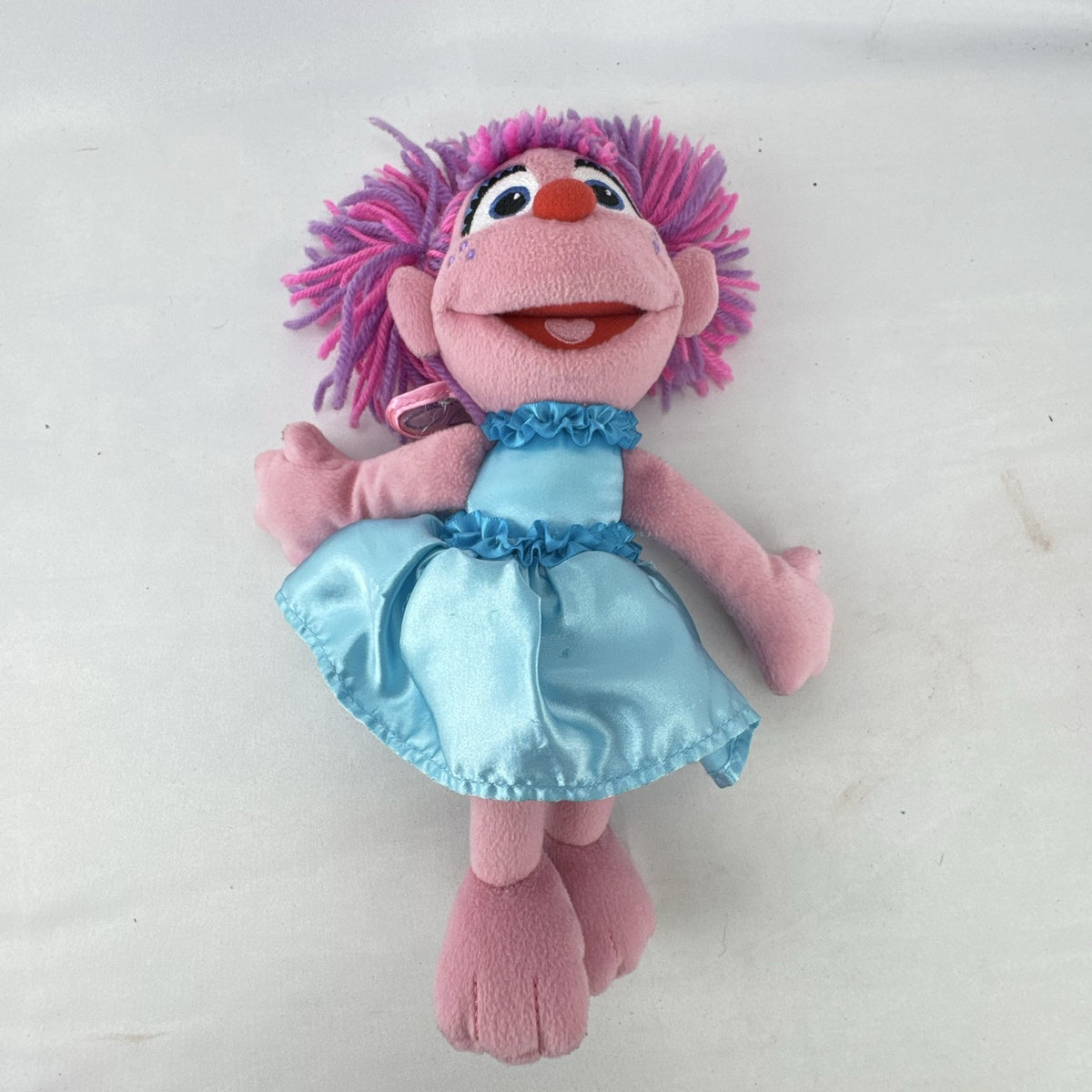 Sesame Street 11-inch Abby Cadabby fairy plush doll wearing blue ruffled dress with wings