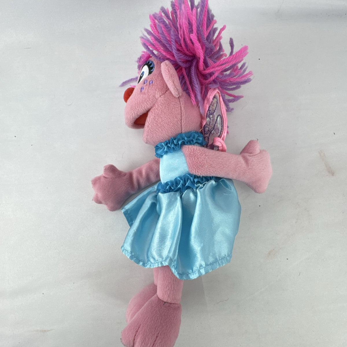 Sesame Street 11-inch Abby Cadabby fairy plush doll wearing blue ruffled dress with wings