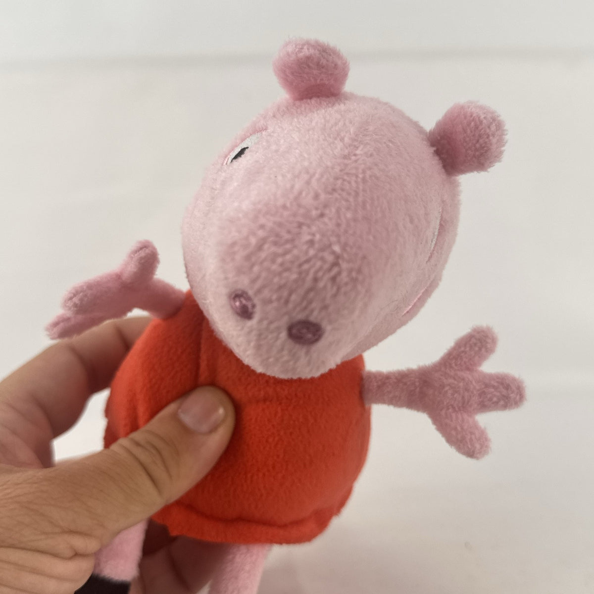 Just Play 7-inch Peppa Pig pink plush bean bag doll wearing a red dress