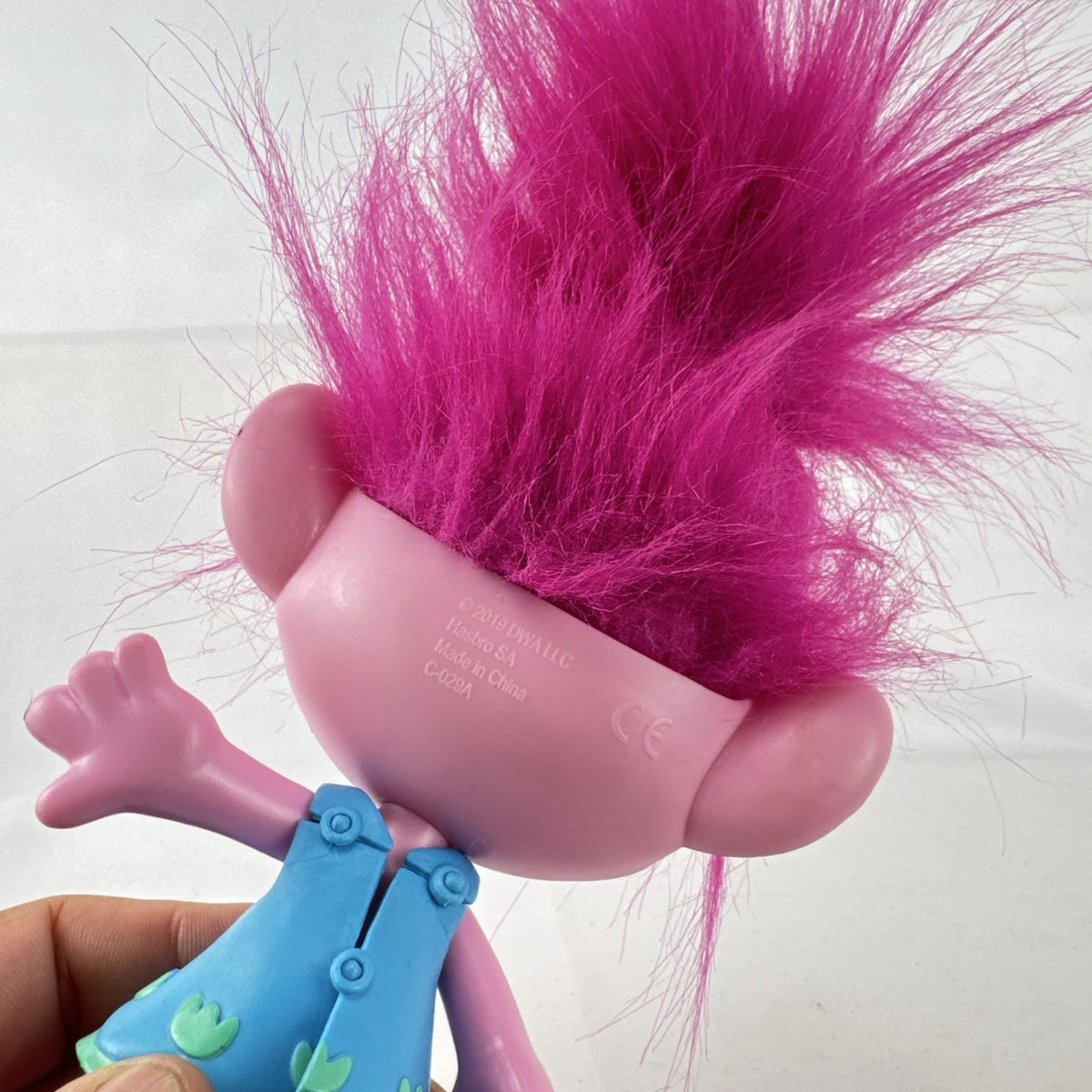 Hasbro DreamWorks Trolls Poppy doll with tall pink hair wearing blue patterned dress