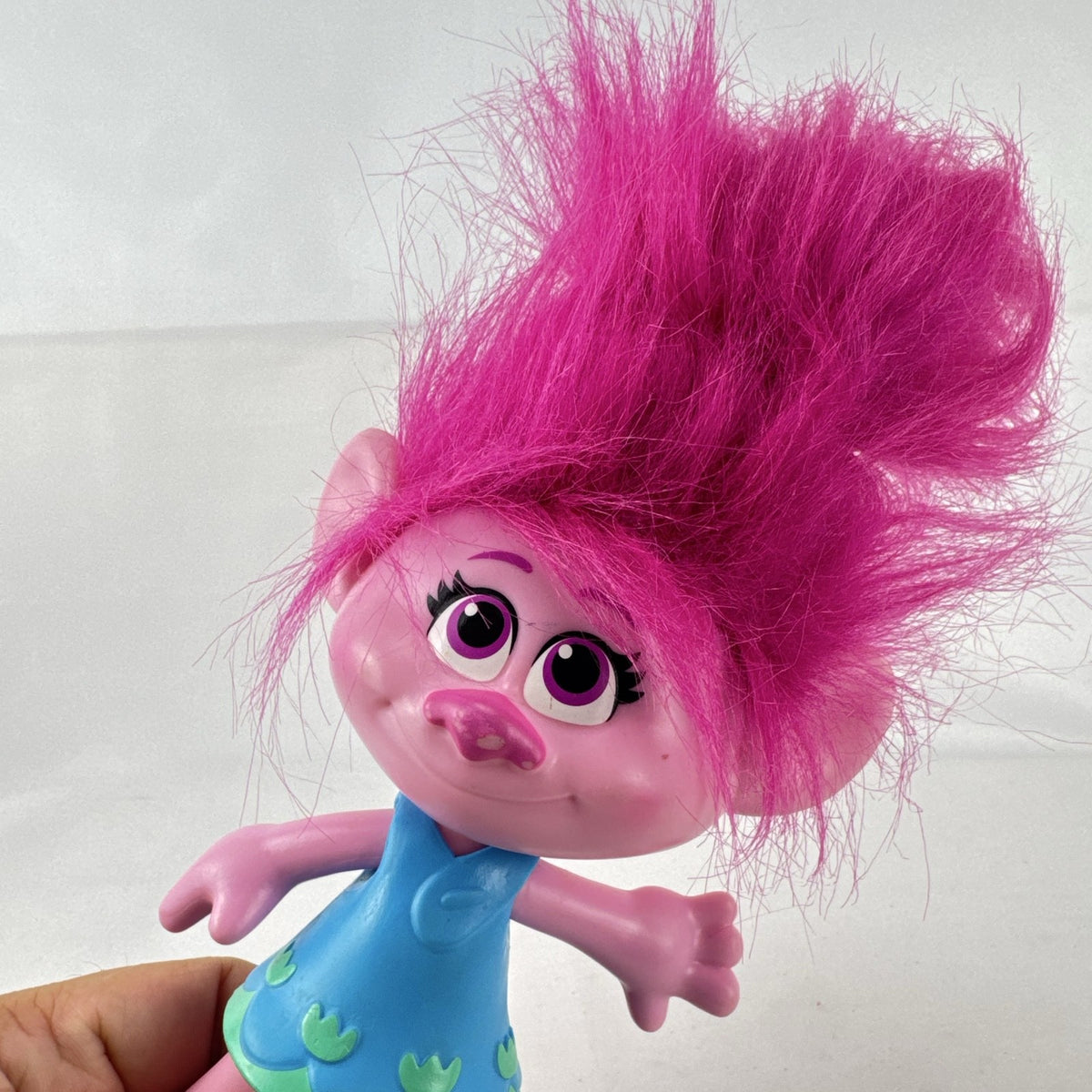 Hasbro DreamWorks Trolls Poppy doll with tall pink hair wearing blue patterned dress