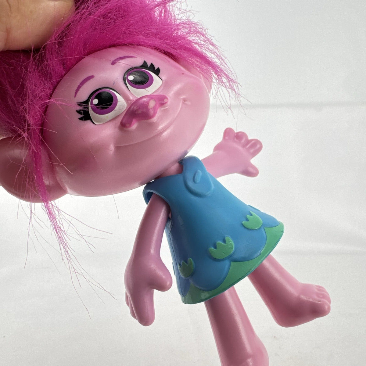 Hasbro DreamWorks Trolls Poppy doll with tall pink hair wearing blue patterned dress
