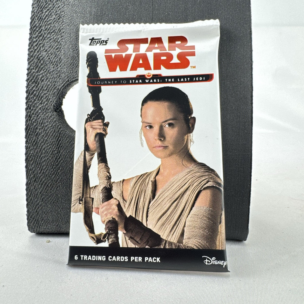 Factory sealed 2017 Topps Star Wars Journey to The Last Jedi card pack featuring Rey on the foil wrapper