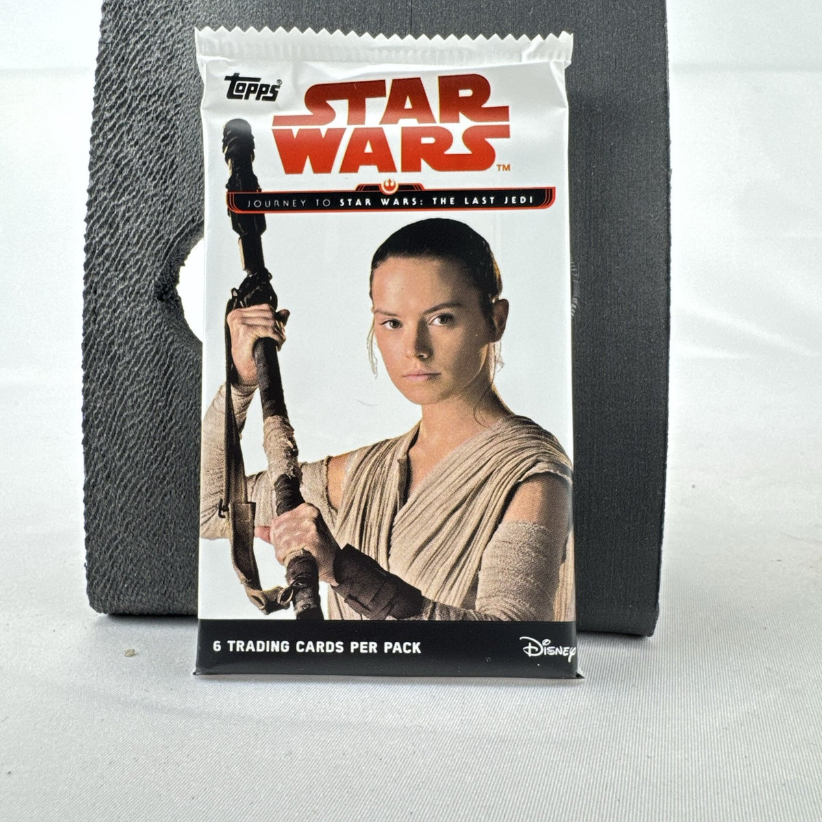 Factory-sealed 2017 Topps Star Wars Journey to The Last Jedi trading card pack featuring Rey wrapper artwork