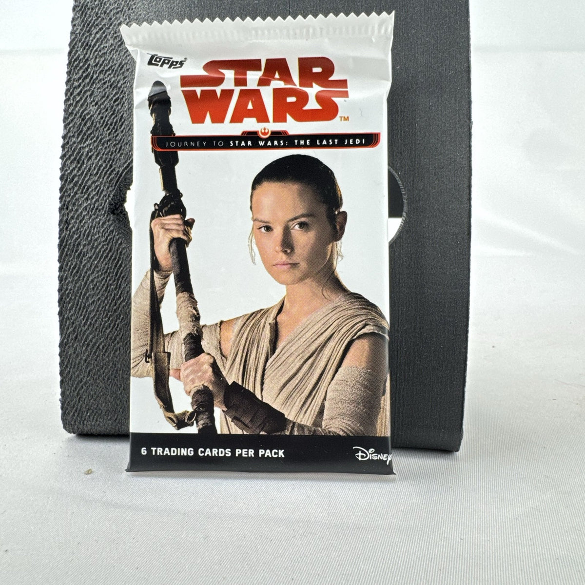 Sealed 2017 Topps Journey to Star Wars: The Last Jedi trading card pack featuring Rey on the foil wrapper