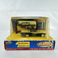 Road Champs 1:43 scale 1957 Ford Fairlane diecast car in yellow and black packaging with display stand