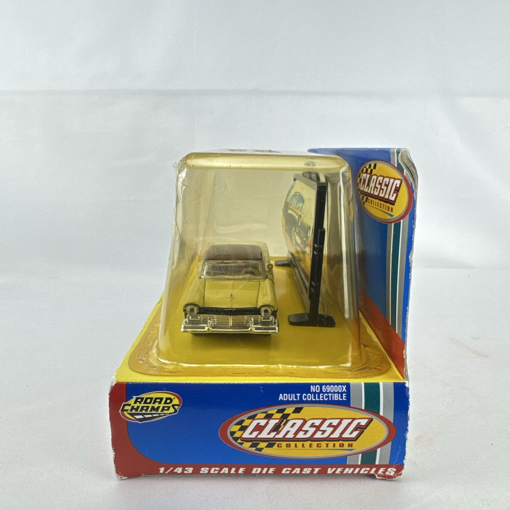Road Champs 1:43 scale 1957 Ford Fairlane diecast car in yellow and black packaging with display stand