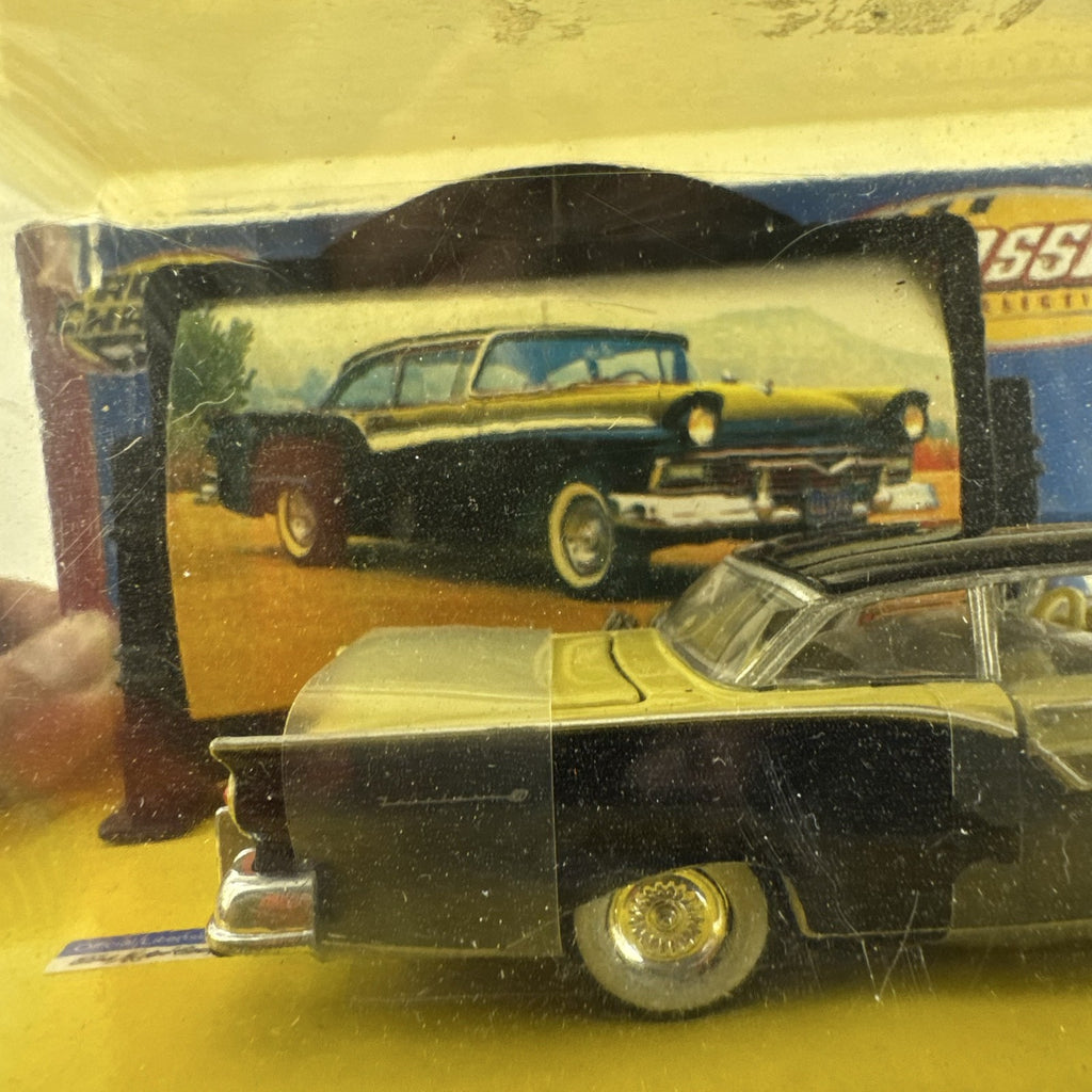 Road Champs 1:43 scale 1957 Ford Fairlane diecast car in yellow and black packaging with display stand