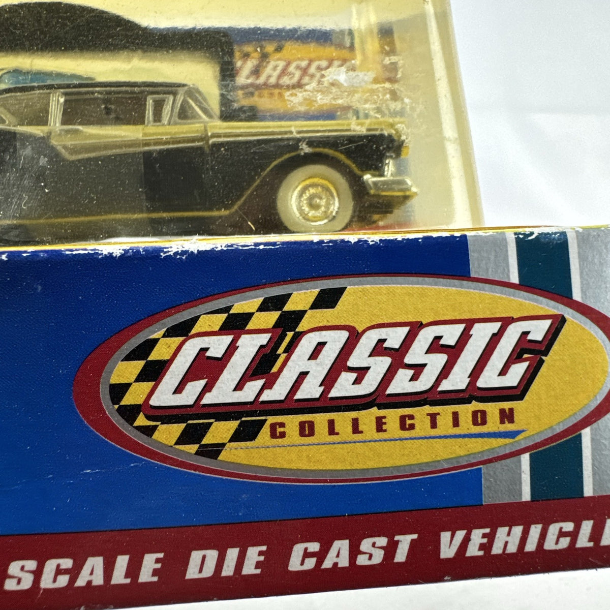 Road Champs 1:43 scale 1957 Ford Fairlane diecast car in yellow and black packaging with display stand
