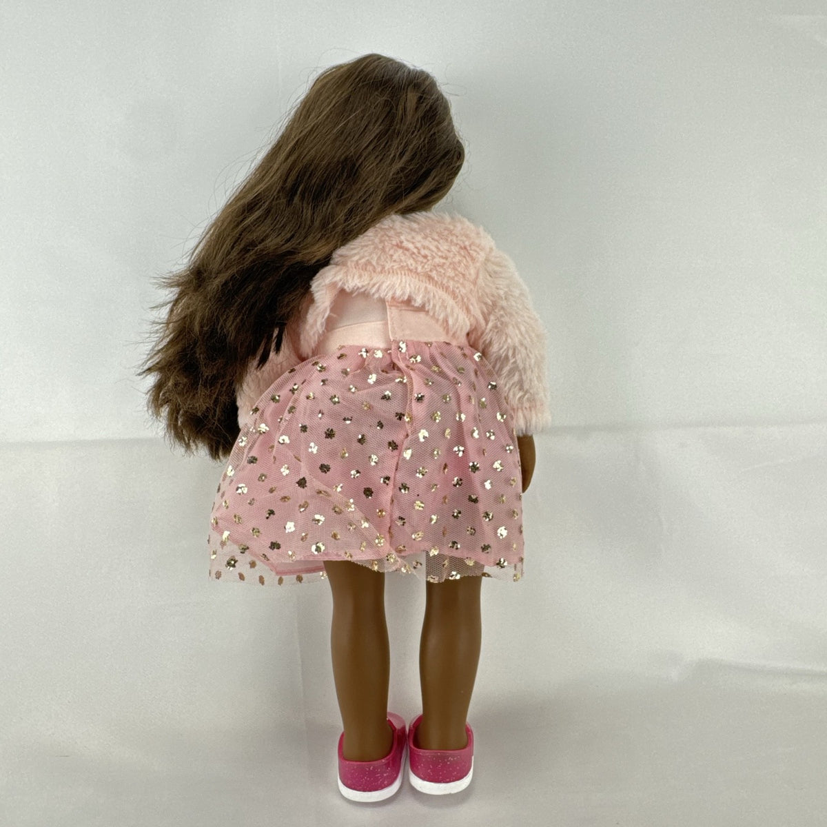 American Girl Truly Me 18-inch doll with dark skin and brown hair wearing a pink sparkle party dress and shrug