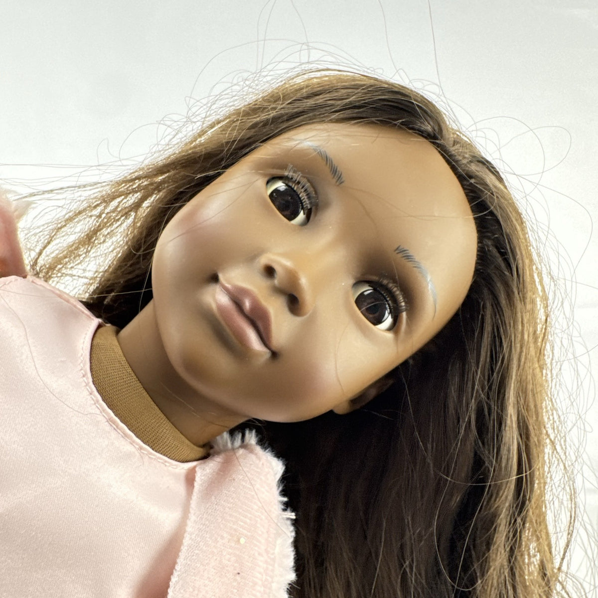 American Girl Truly Me 18-inch doll with dark skin and brown hair wearing a pink sparkle party dress and shrug