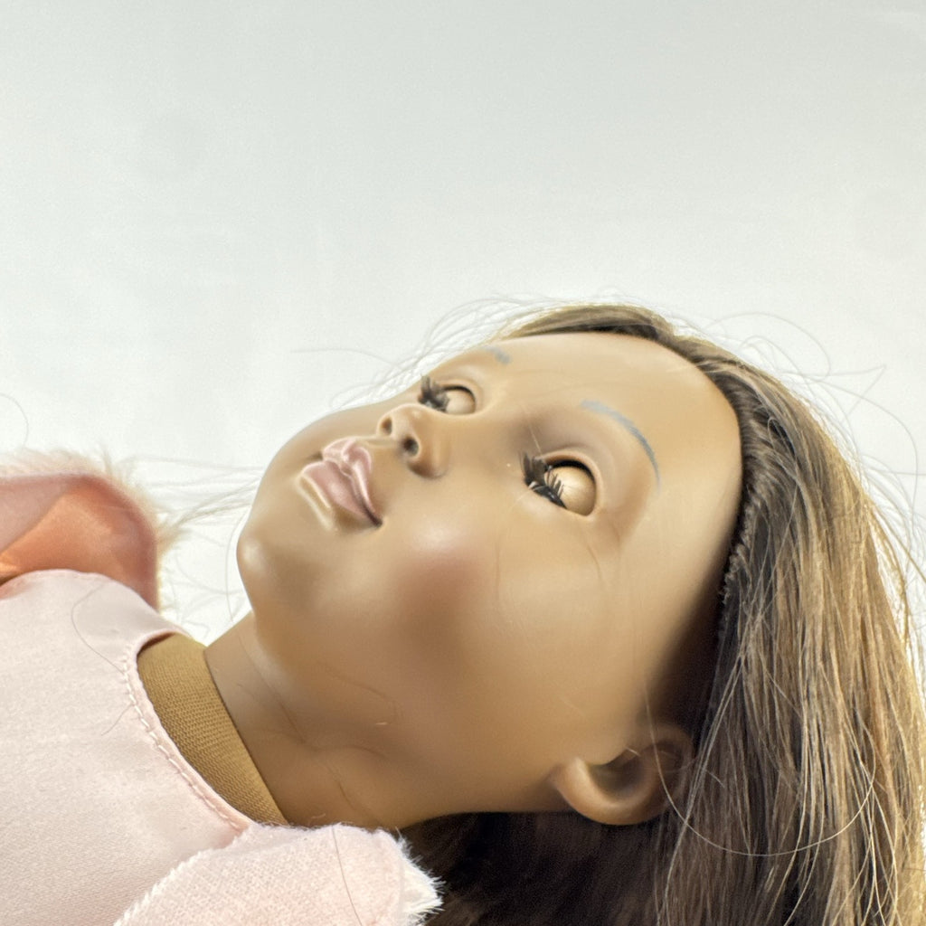 American Girl Truly Me 18-inch doll with dark skin and brown hair wearing a pink sparkle party dress and shrug
