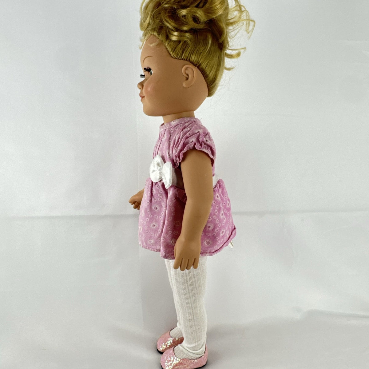 Cititoy 18-inch vinyl girl doll with blonde hair updo, green eyes, freckles, and pink floral outfit with glitter shoes.