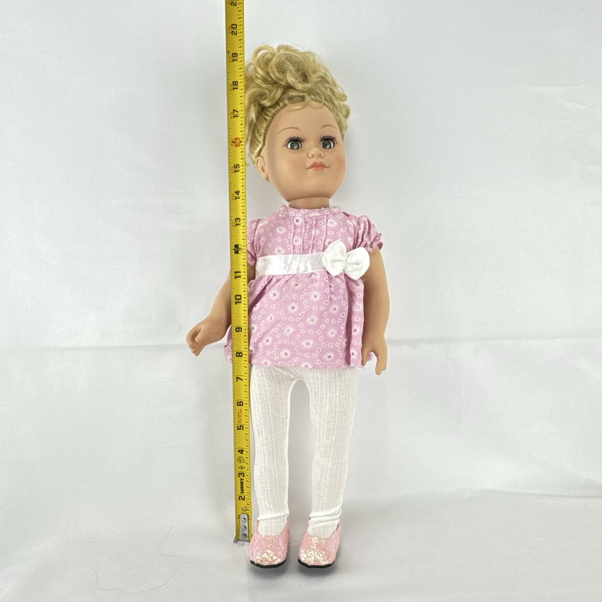 Cititoy 18-inch vinyl girl doll with blonde hair updo, green eyes, freckles, and pink floral outfit with glitter shoes.