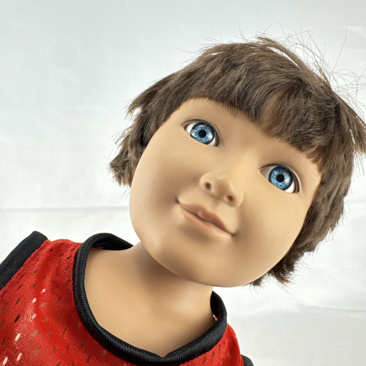 Cititoy 18-inch vinyl boy play doll with blue eyes and brown hair wearing a red basketball jersey and sneakers