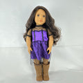Battat Our Generation 18-inch vinyl doll with wavy dark brown hair, wearing a purple polka-dot dress and tan boots.