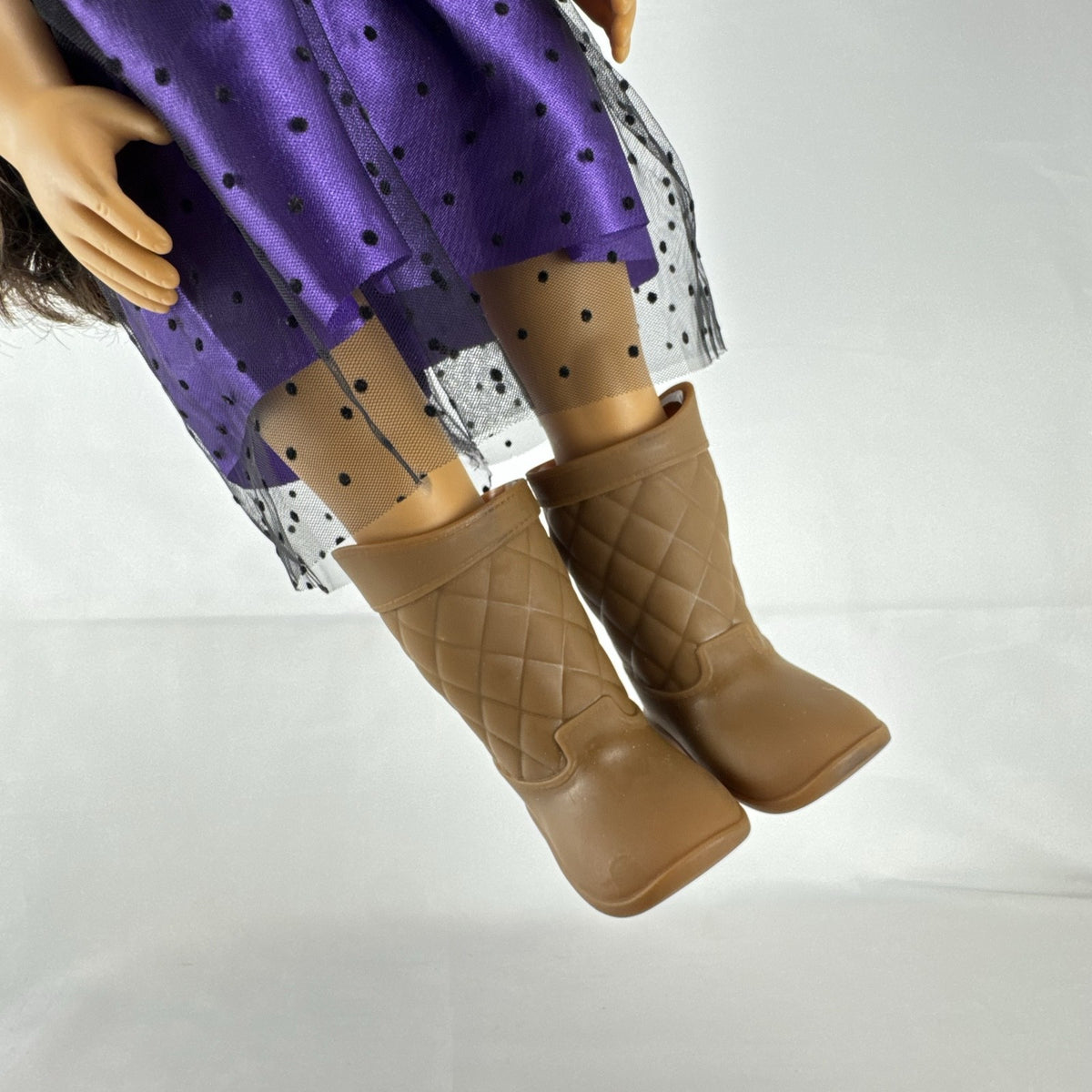 Battat Our Generation 18-inch vinyl doll with wavy dark brown hair, wearing a purple polka-dot dress and tan boots.