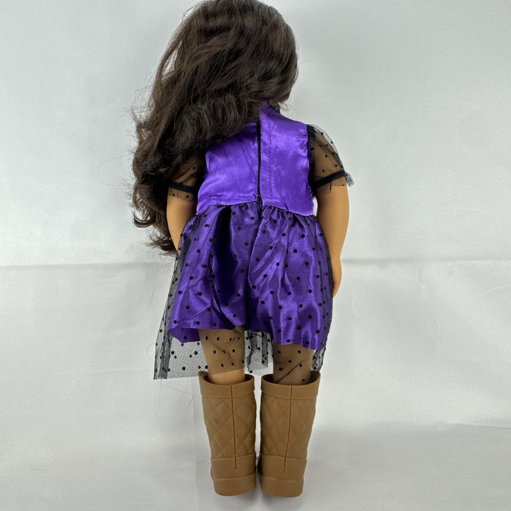 Battat Our Generation 18-inch vinyl doll with wavy dark brown hair, wearing a purple polka-dot dress and tan boots.