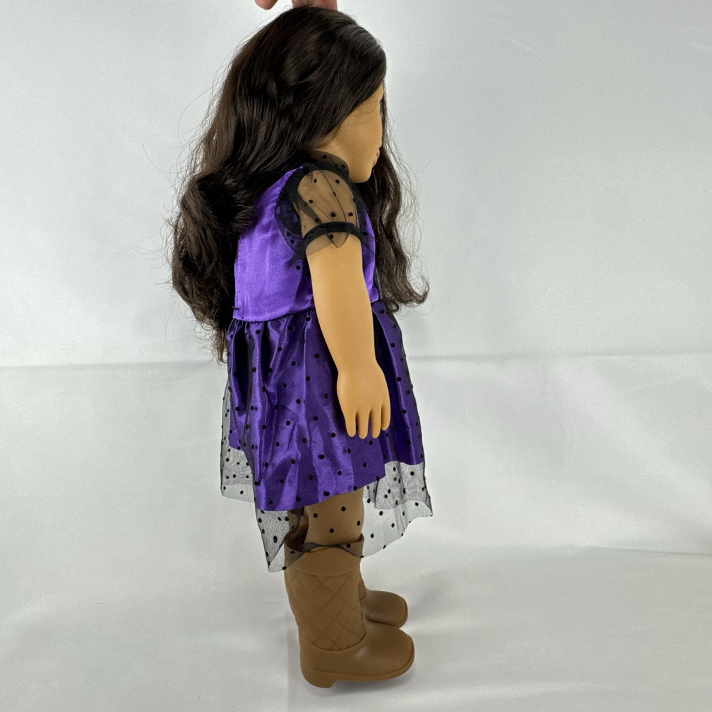 Battat Our Generation 18-inch vinyl doll with wavy dark brown hair, wearing a purple polka-dot dress and tan boots.