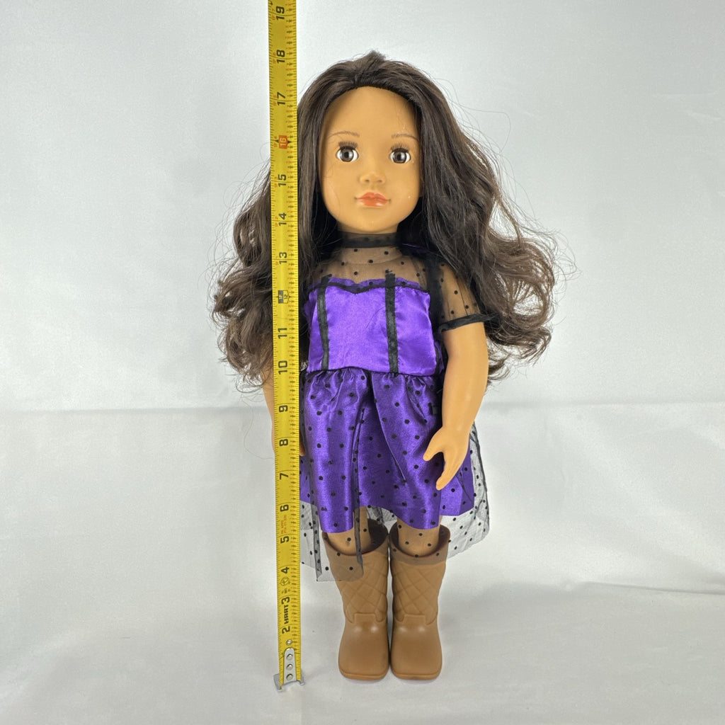 Battat Our Generation 18-inch vinyl doll with wavy dark brown hair, wearing a purple polka-dot dress and tan boots.