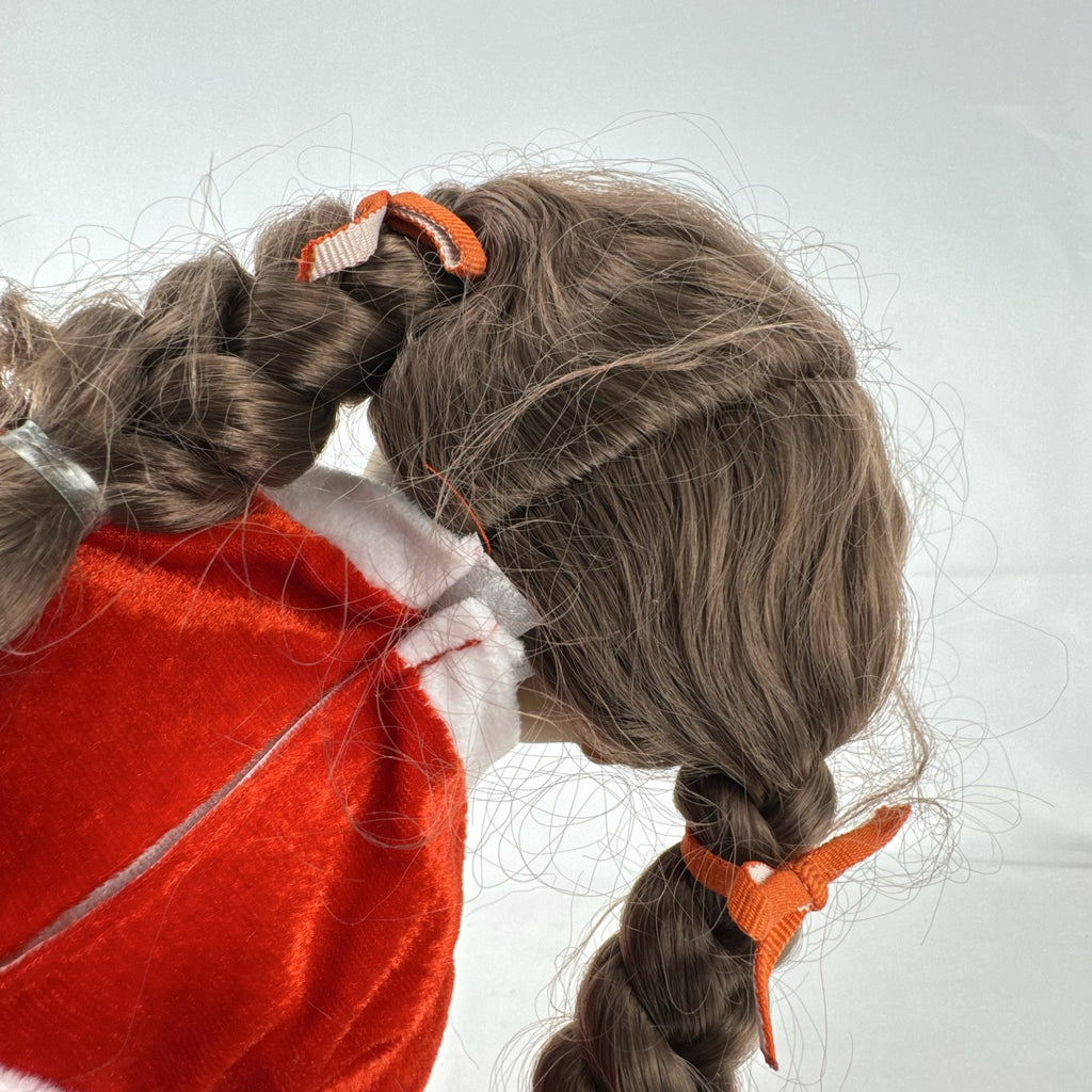 Battat Our Generation 18-inch doll with brown braided pigtails wearing a red and white holiday Santa dress and boots