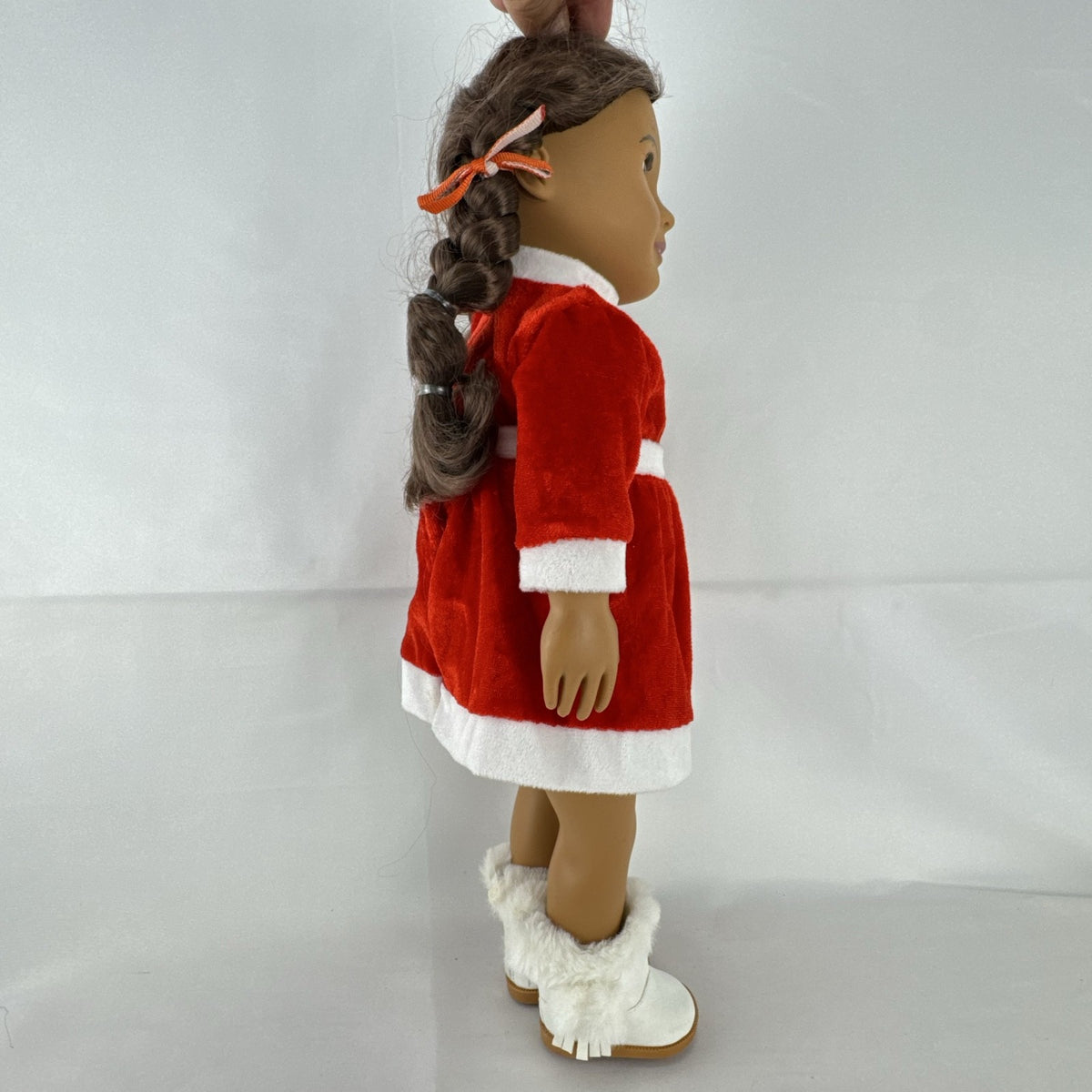 Battat Our Generation 18-inch doll with brown braided pigtails wearing a red and white holiday Santa dress and boots