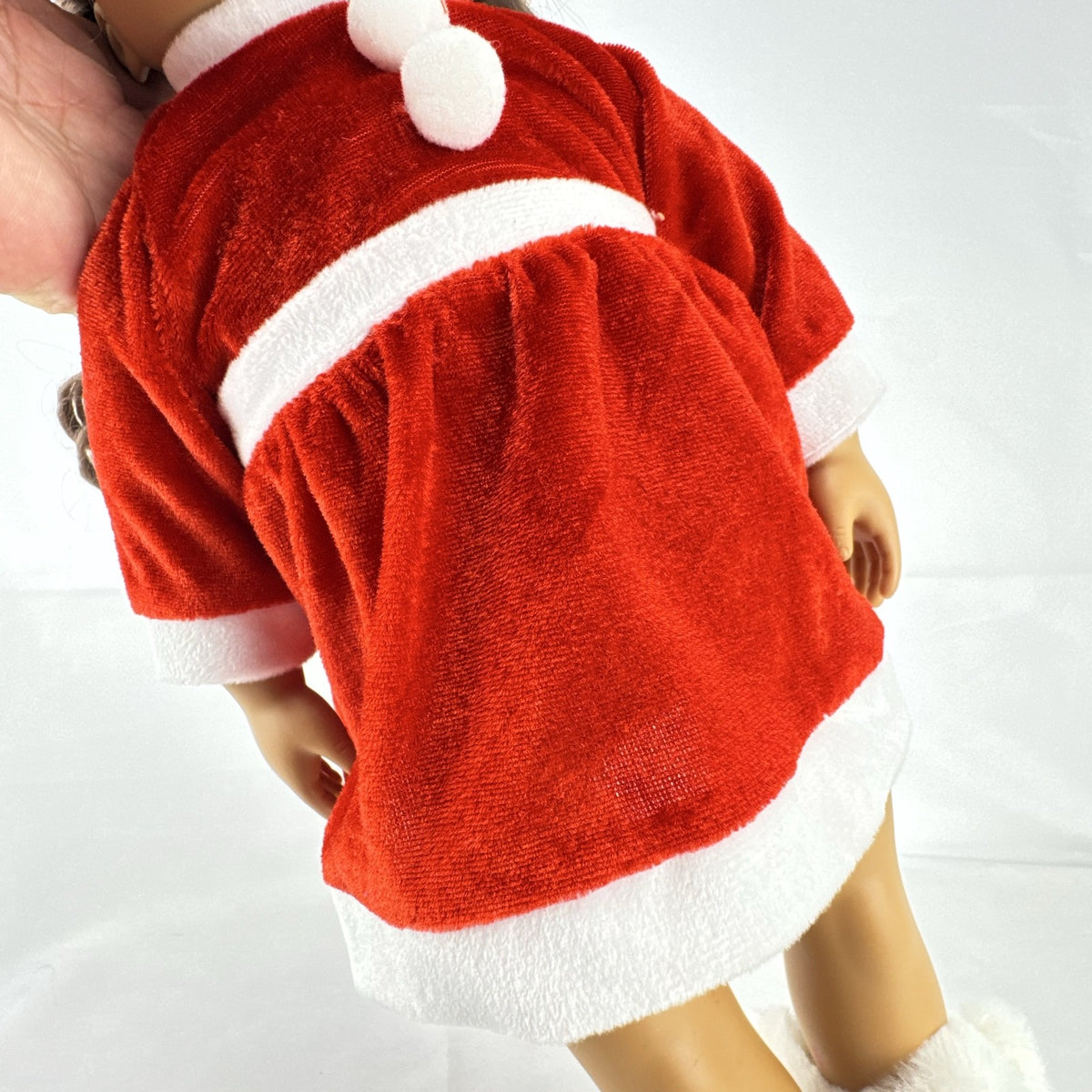 Battat Our Generation 18-inch doll with brown braided pigtails wearing a red and white holiday Santa dress and boots