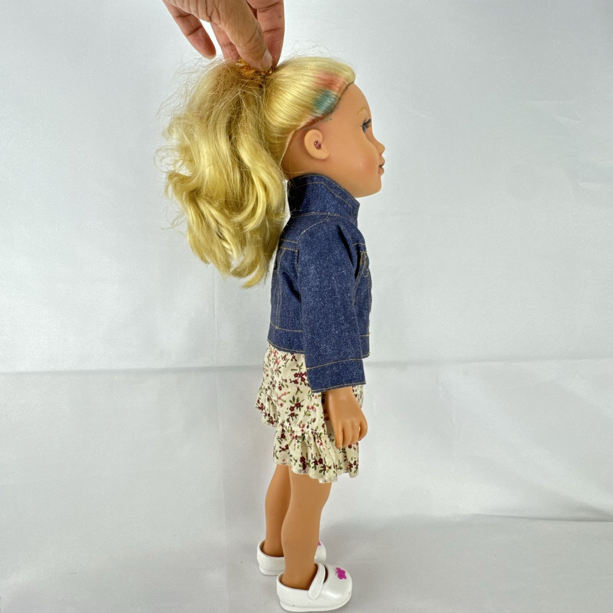 Geoffrey LLC Journey Girls 18-inch doll with blonde rainbow-streaked hair, floral dress, and denim jacket.