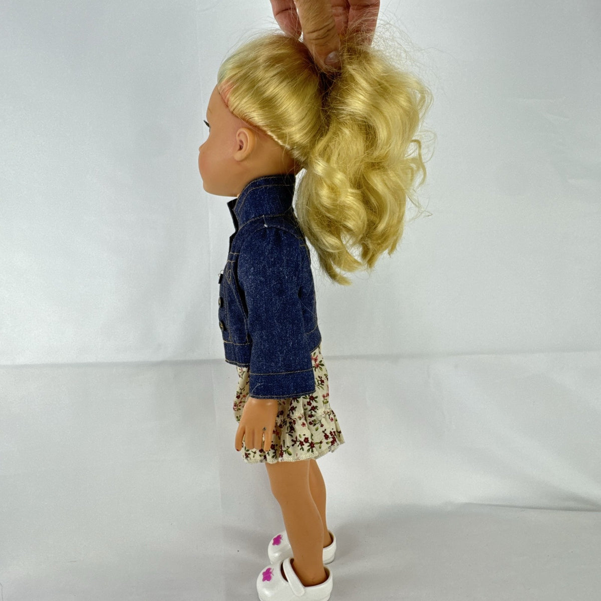 Geoffrey LLC Journey Girls 18-inch doll with blonde rainbow-streaked hair, floral dress, and denim jacket.