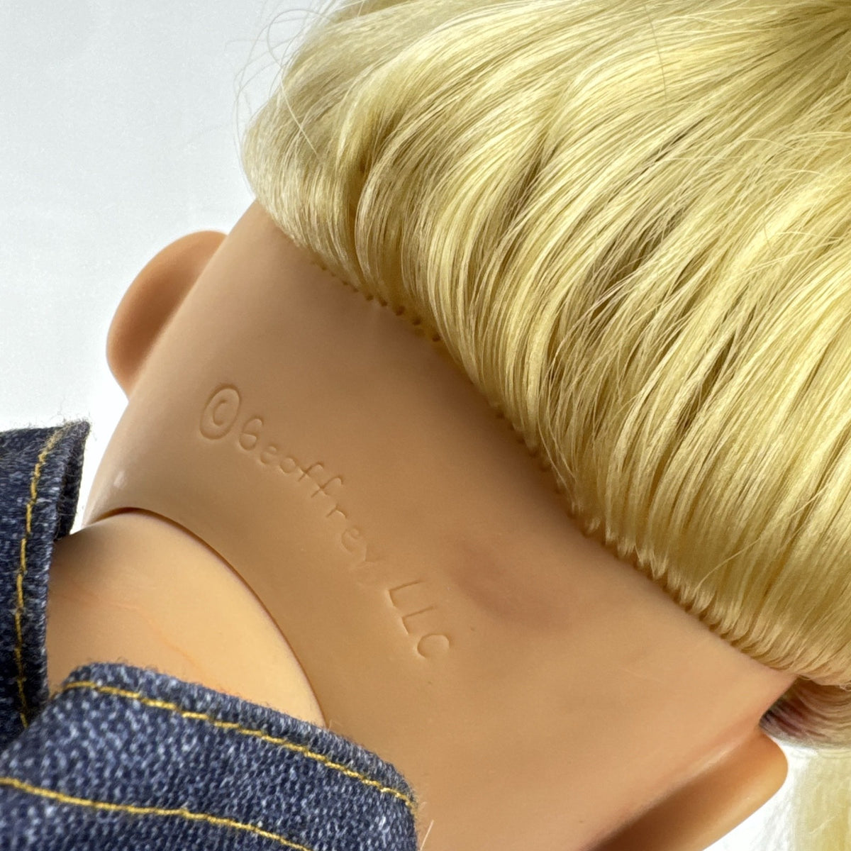 Geoffrey LLC Journey Girls 18-inch doll with blonde rainbow-streaked hair, floral dress, and denim jacket.