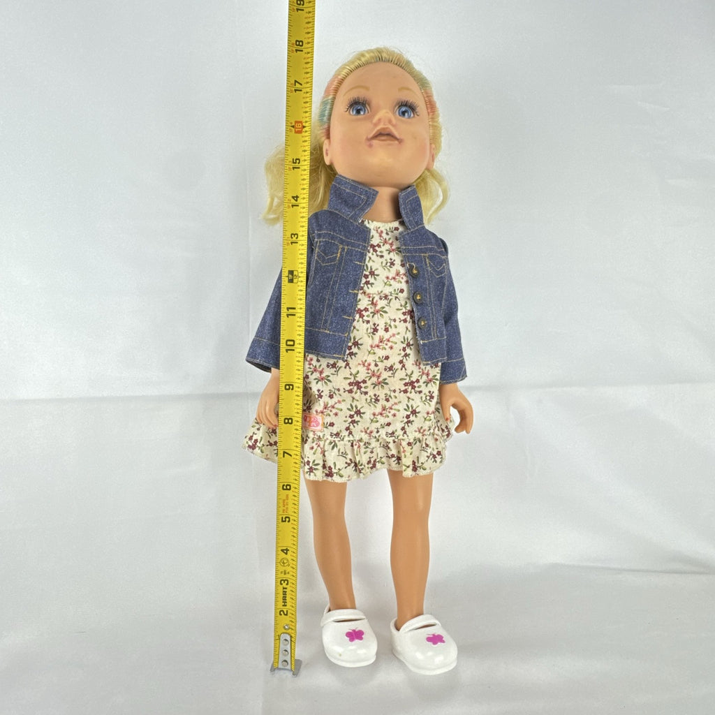 Geoffrey LLC Journey Girls 18-inch doll with blonde rainbow-streaked hair, floral dress, and denim jacket.