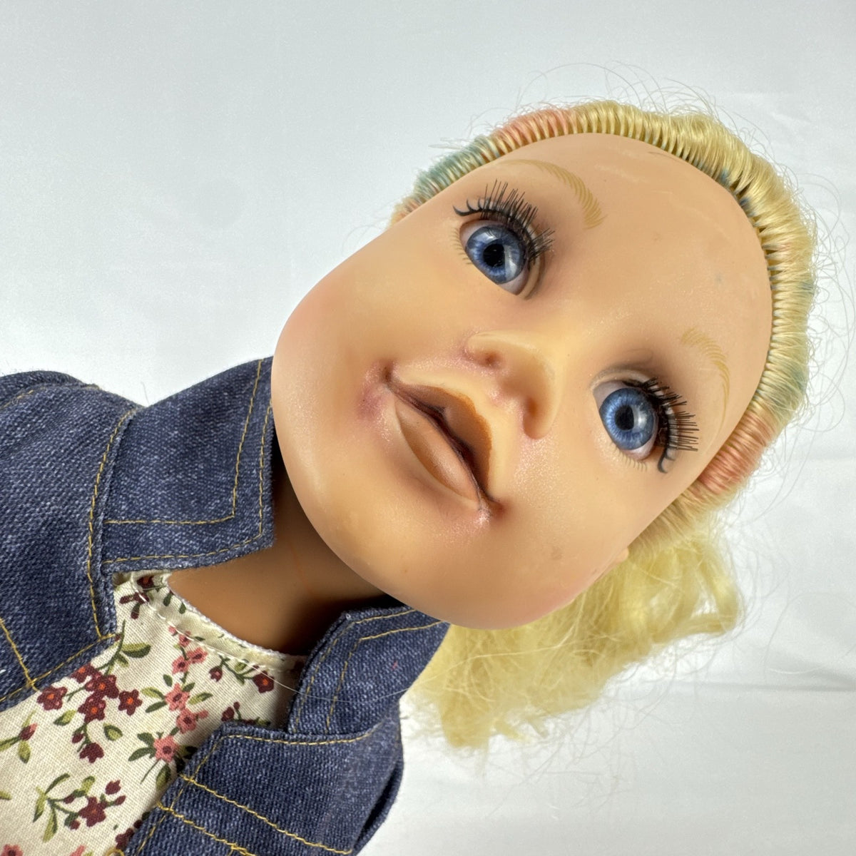 Geoffrey LLC Journey Girls 18-inch doll with blonde rainbow-streaked hair, floral dress, and denim jacket.