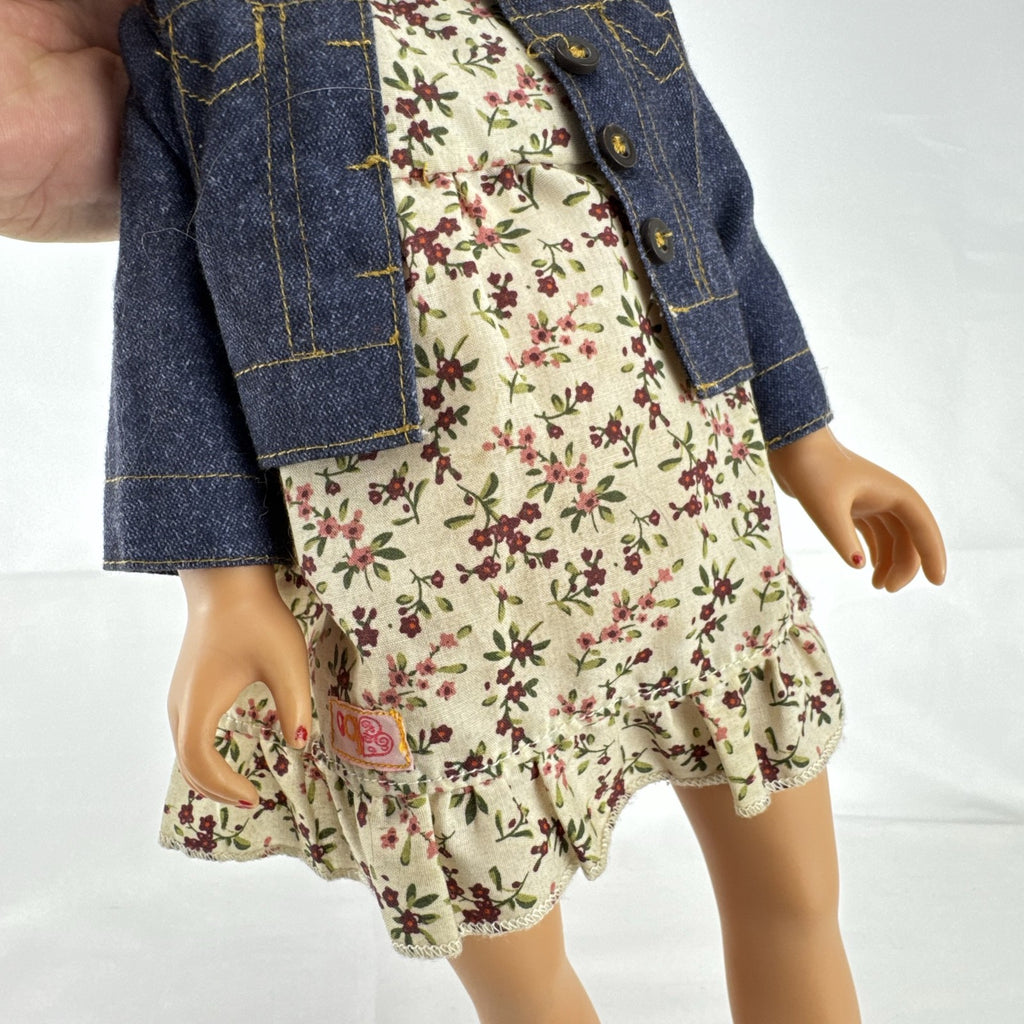 Geoffrey LLC Journey Girls 18-inch doll with blonde rainbow-streaked hair, floral dress, and denim jacket.
