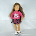 Battat Our Generation 18-inch brunette play doll wearing a pink cupcake shirt, tulle skirt, and panda shoes.