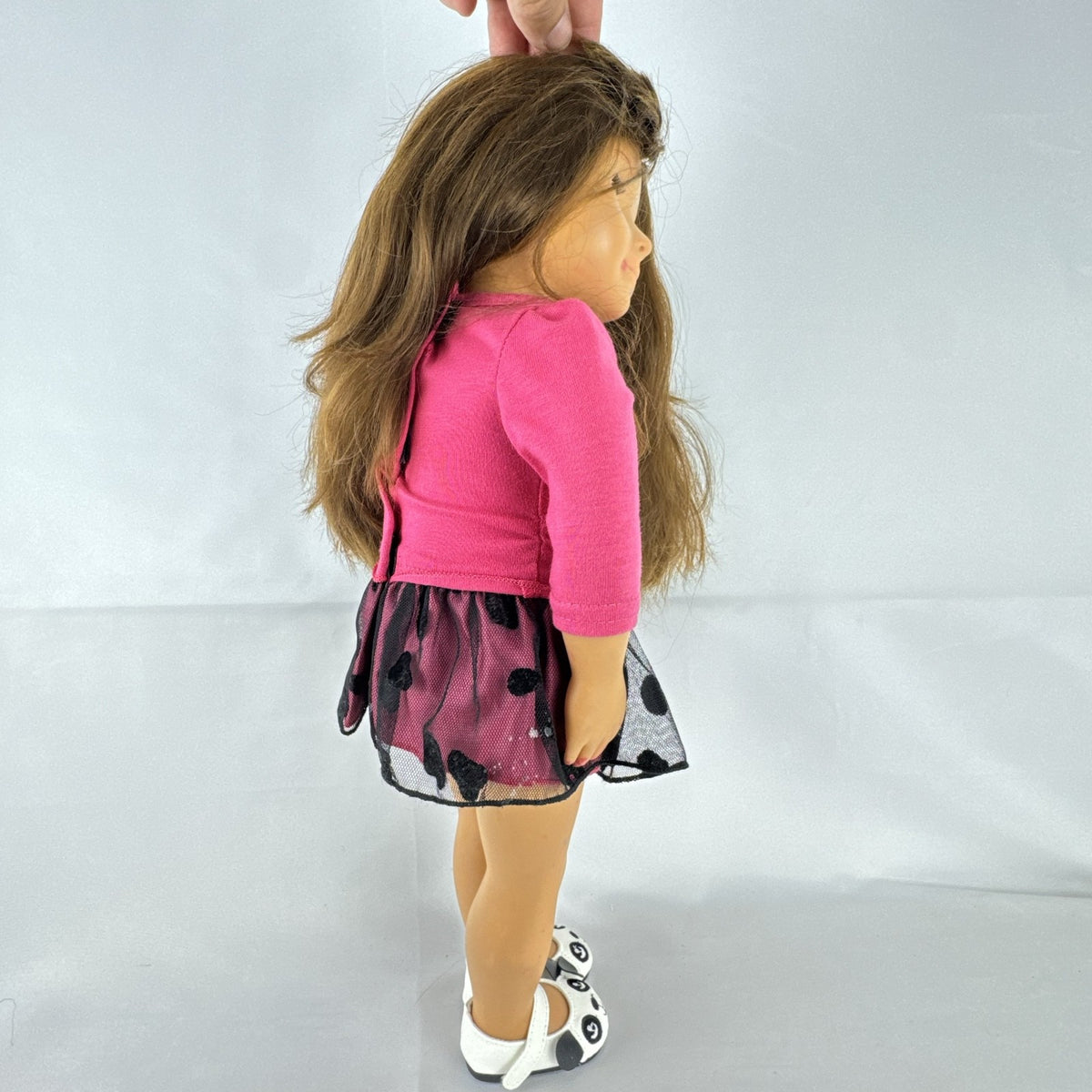 Battat Our Generation 18-inch brunette play doll wearing a pink cupcake shirt, tulle skirt, and panda shoes.