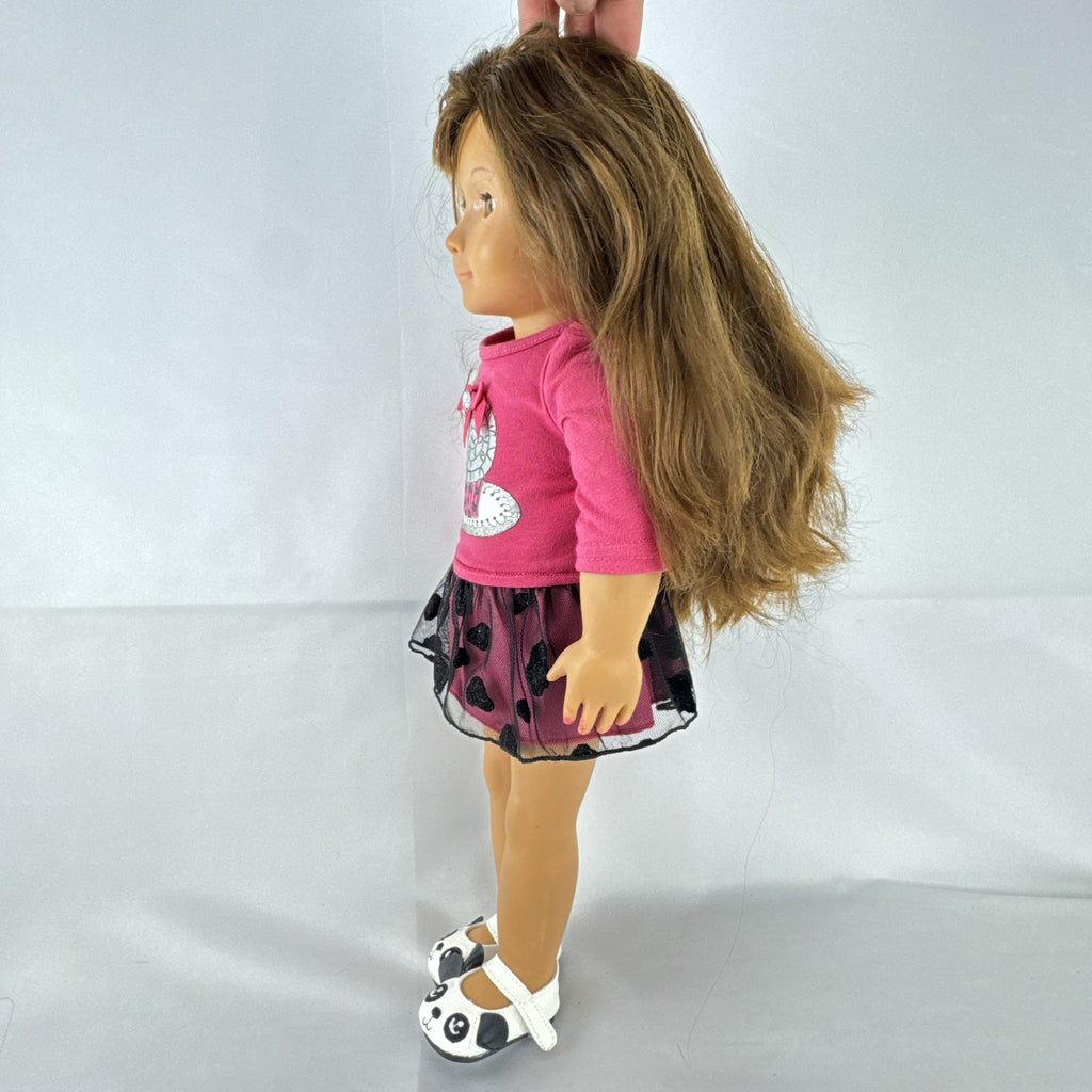 Battat Our Generation 18-inch brunette play doll wearing a pink cupcake shirt, tulle skirt, and panda shoes.