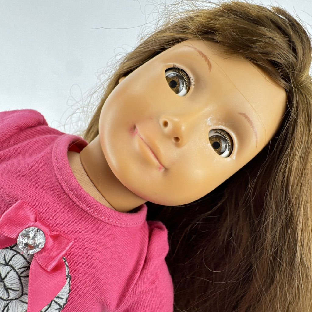 Battat Our Generation 18-inch brunette play doll wearing a pink cupcake shirt, tulle skirt, and panda shoes.