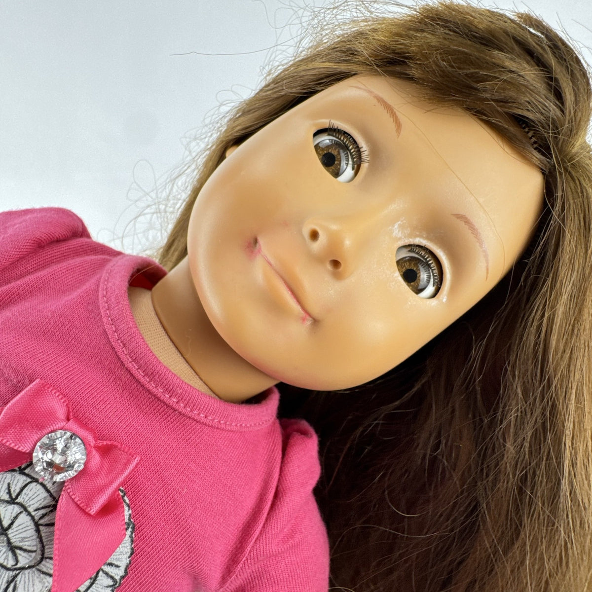 Battat Our Generation 18-inch brunette play doll wearing a pink cupcake shirt, tulle skirt, and panda shoes.