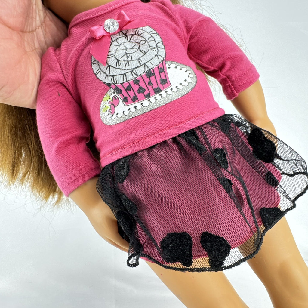 Battat Our Generation 18-inch brunette play doll wearing a pink cupcake shirt, tulle skirt, and panda shoes.