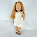 Battat Our Generation 18-inch doll with auburn hair and green eyes wearing cream ruffle dress and pink shrug