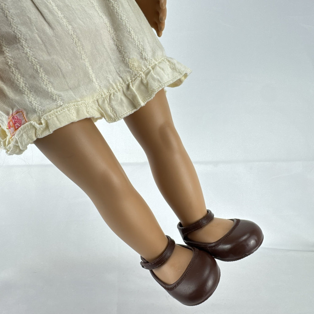 Battat Our Generation 18-inch doll with auburn hair and green eyes wearing cream ruffle dress and pink shrug